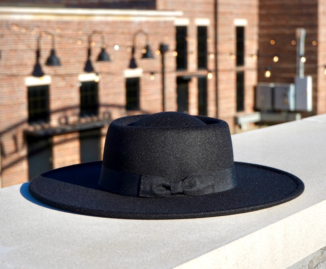 Black color bolero crown style wide brim hat with a bowtie headband.