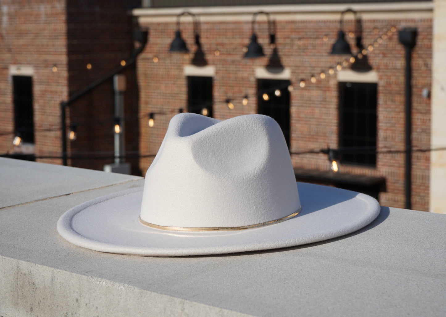 Hendrix wide brim hat with a gold herribone bone chain headband.