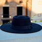 A picture of a black color bolero crown fedora hat with a headband.