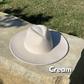 Cream colored wide brim fedora.