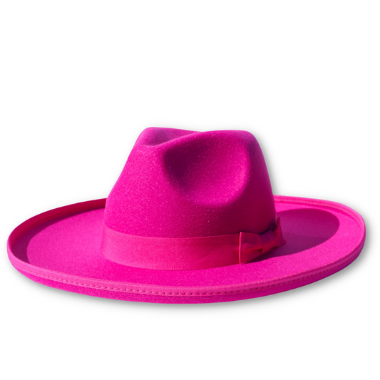 A product photo of a fuchsia colored pencil brim fedora with a ribbon headband.